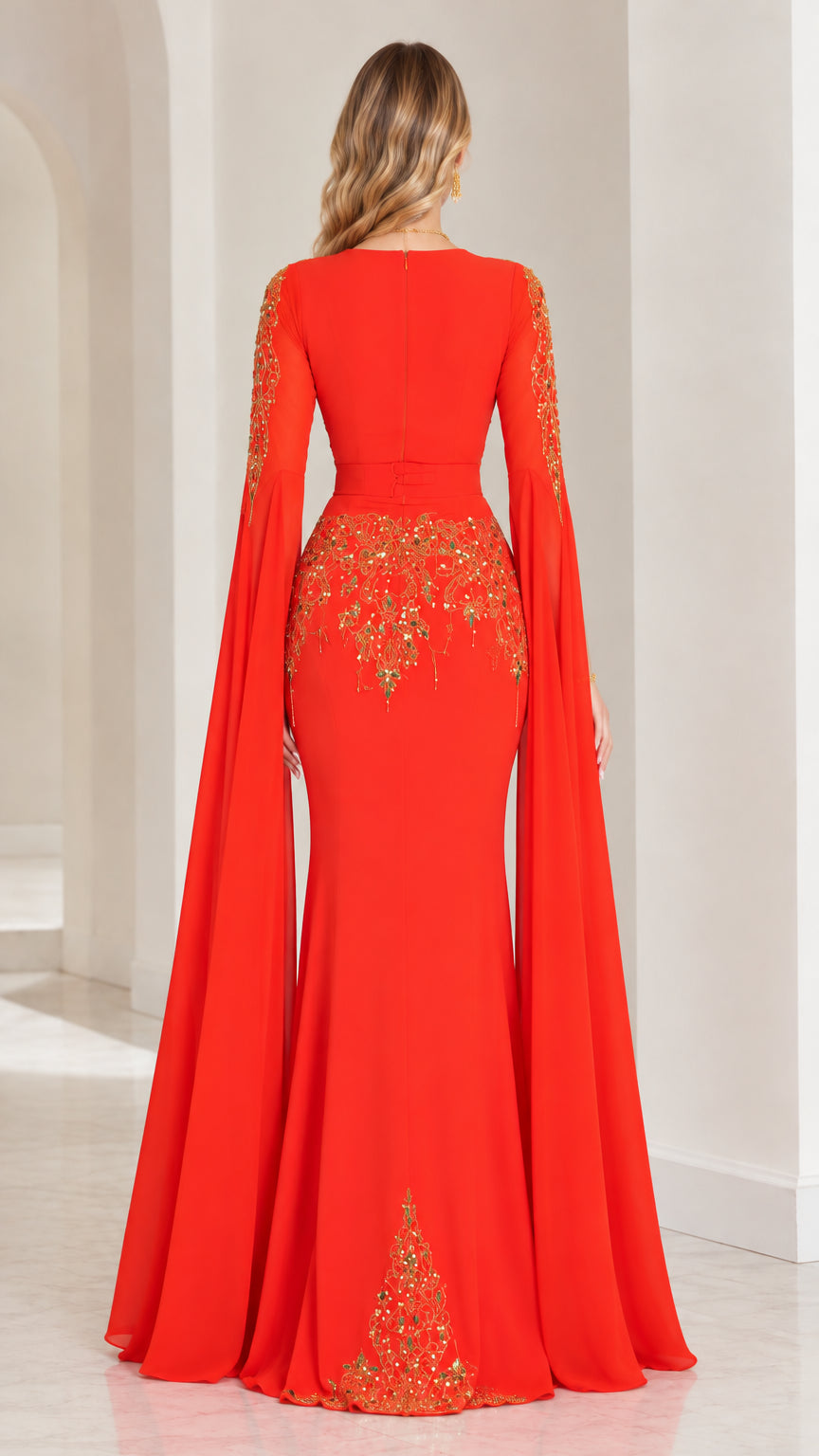 Back view of red evening gown showing fitted silhouette and cape sleeve drapery