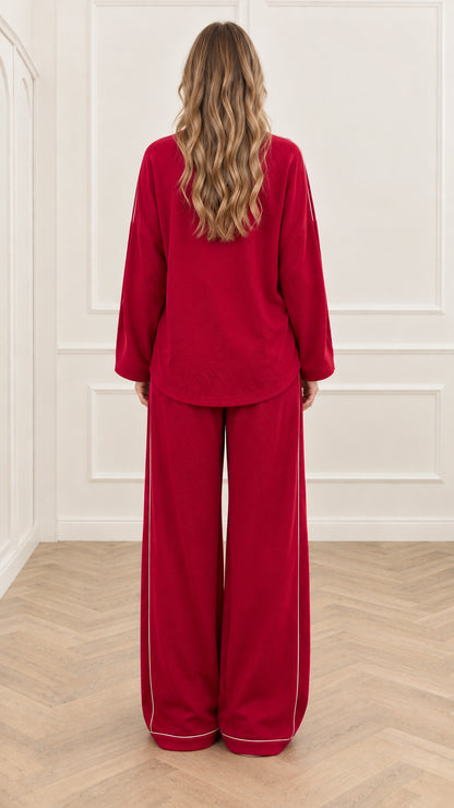 Back view of woman wearing red long sleeve top and wide leg lounge pants