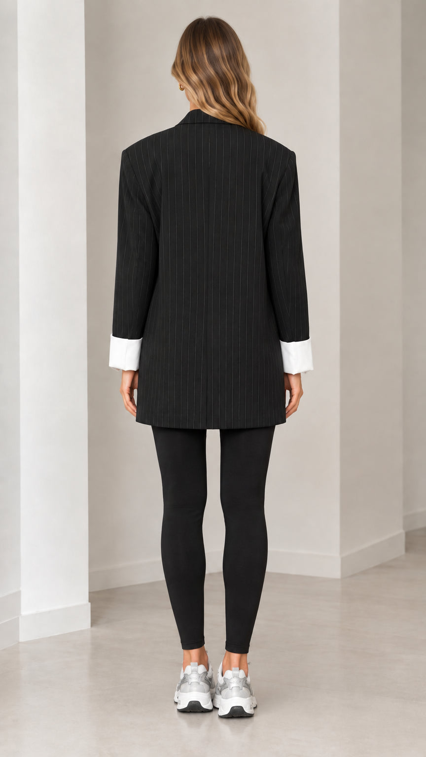 Back full-length view of tailored black pinstripe blazer
