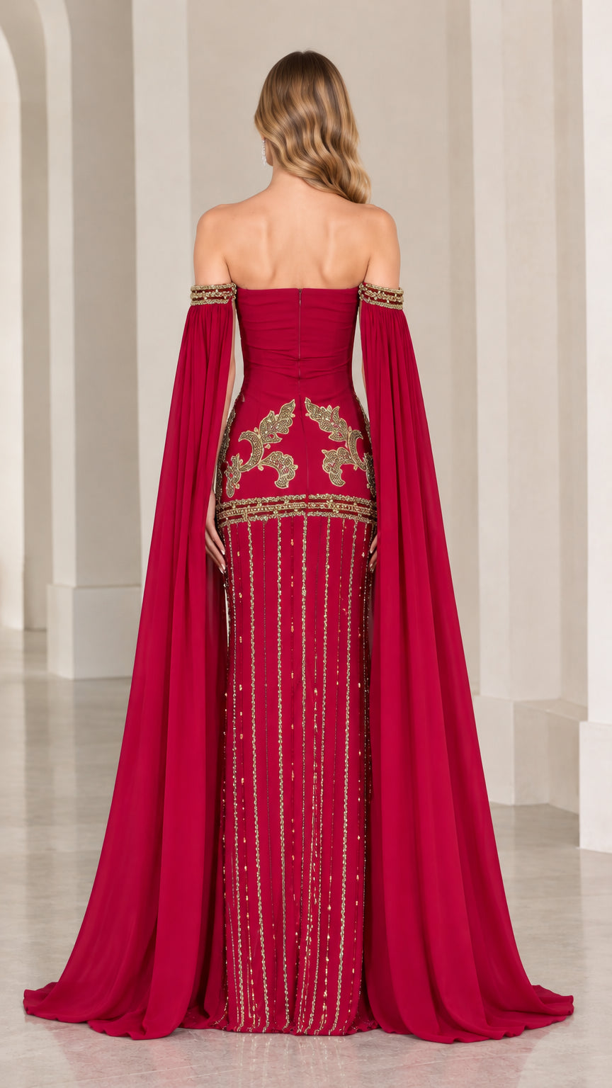 Back view of burgundy cape sleeve gown highlighting embroidered lower skirt and back zipper