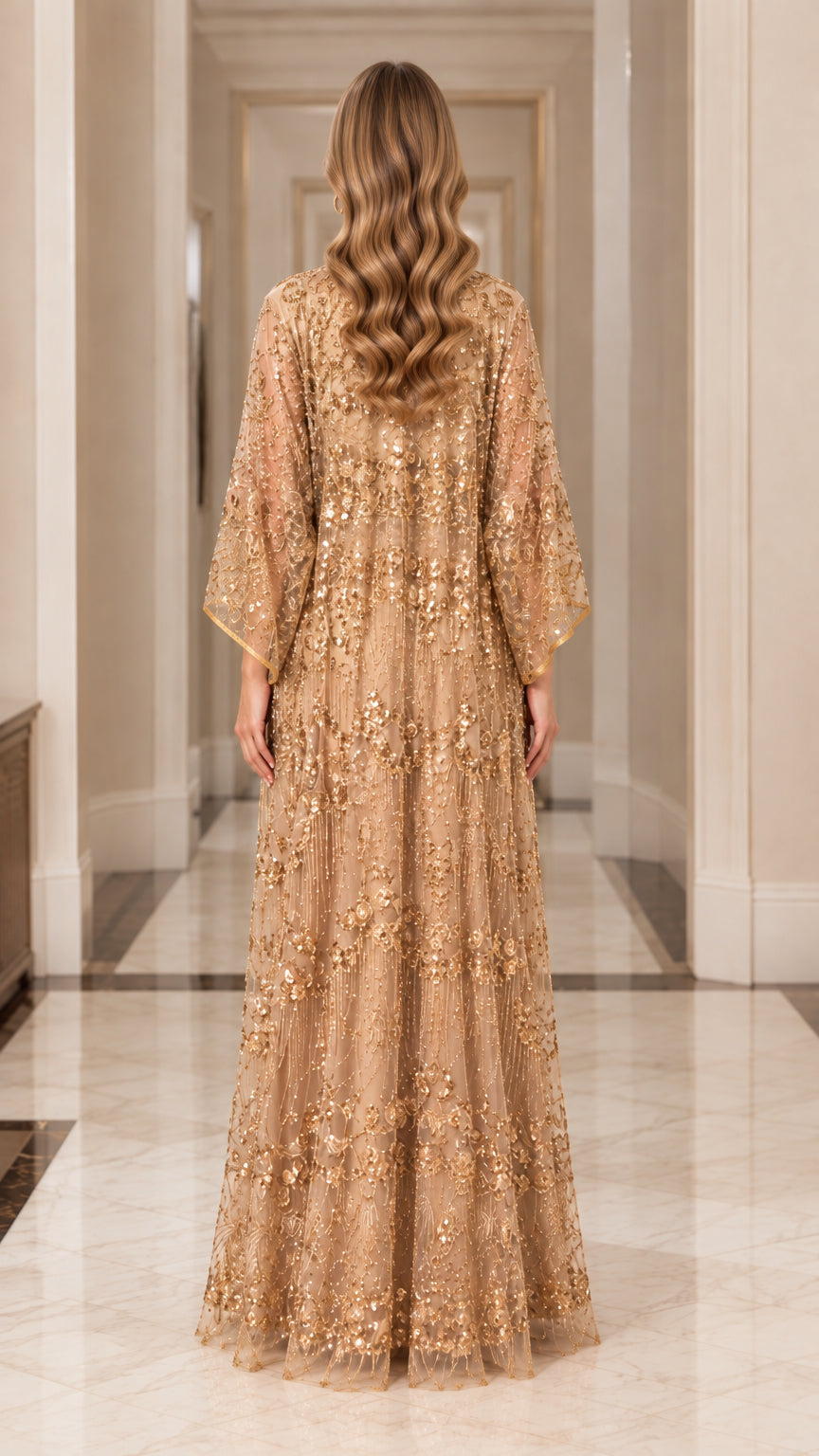 Back view of model showcasing the gold embellished floor-length sheer cape