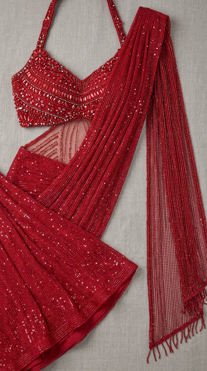 Close-up flat lay of red beaded bodice and pleated drape sash detailing