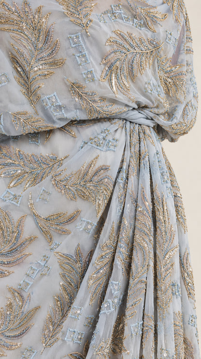 Close-up detail of metallic leaf embroidery and gathered draped waistline