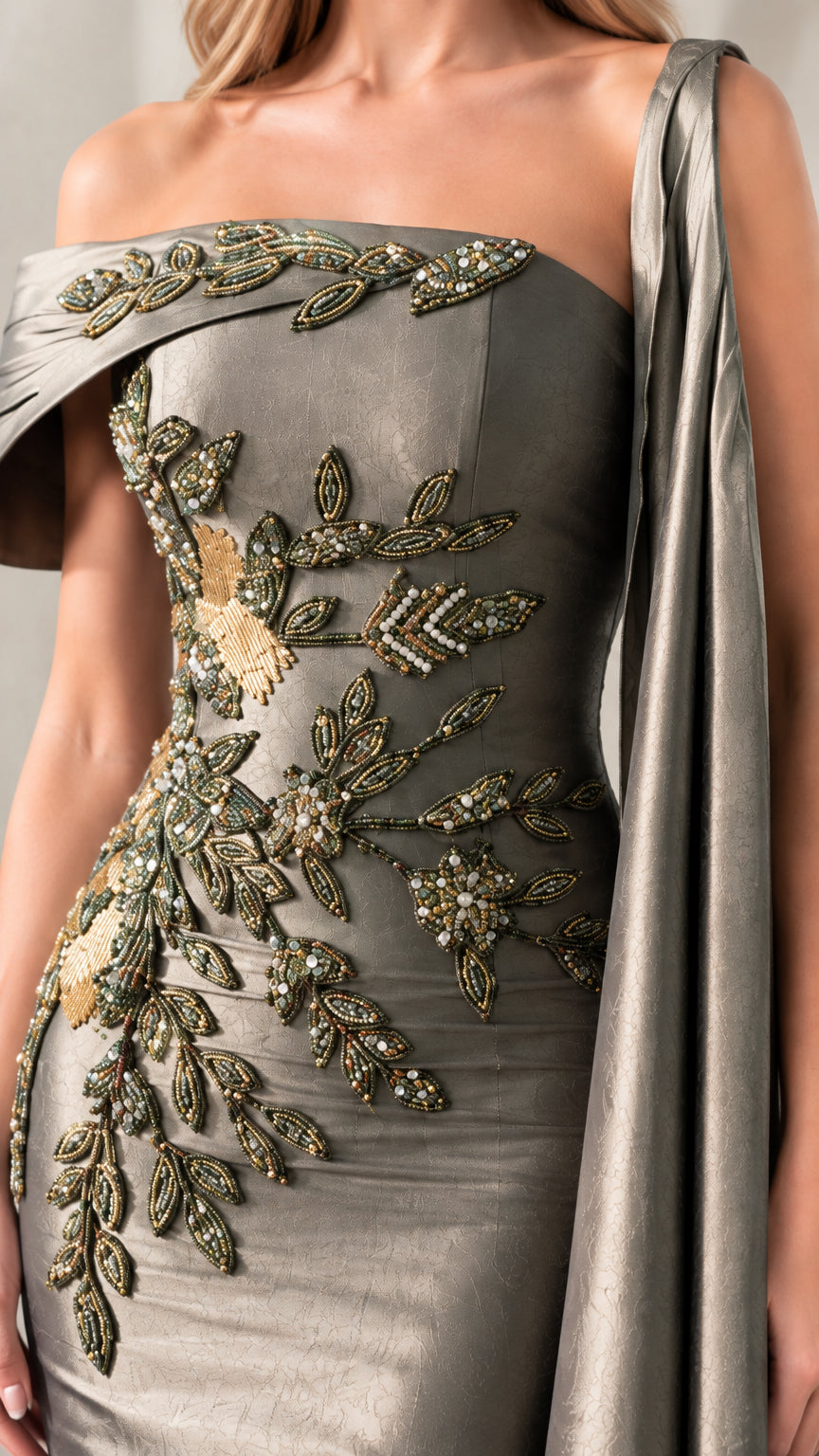 Close-up detail of metallic floral beading and folded neckline on Charcoal gown