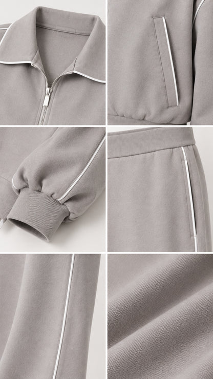 Close-up details of collar zipper, piped pocket, ribbed cuffs, and soft knit fabric in Heather Grey