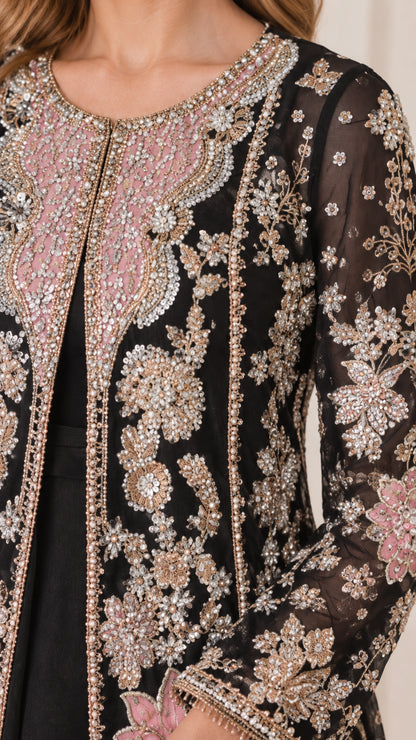 Close-up detail of pink and gold floral beadwork, sequins, and neckline on jacket