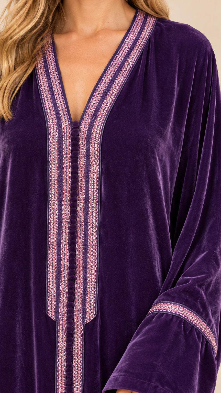 Close-up detail of embroidered V-neckline and trim on purple velvet dress