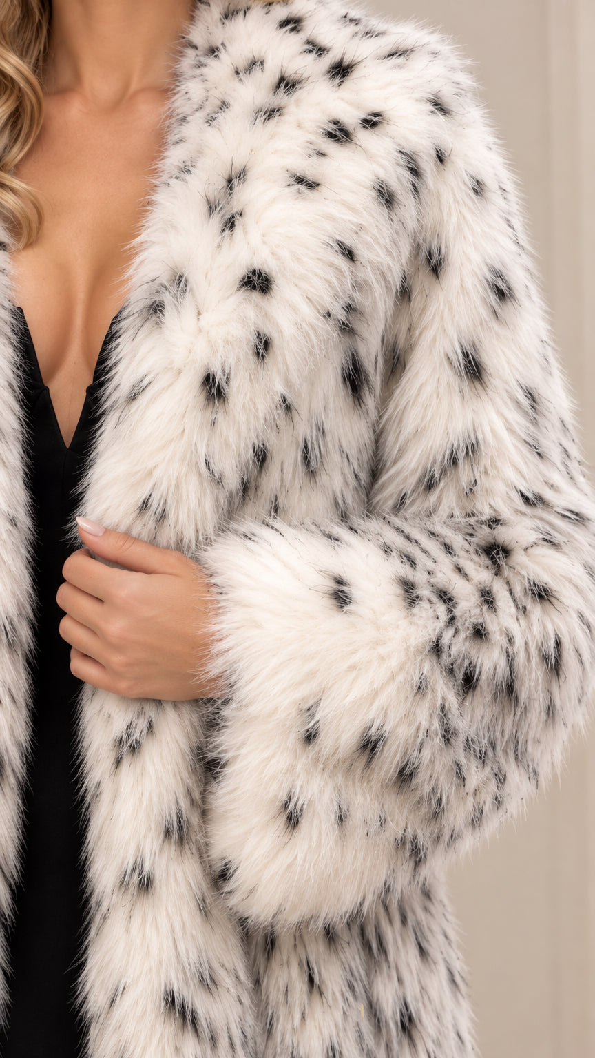 Close-up detail of textured white and black spotted faux fur lapel and sleeve