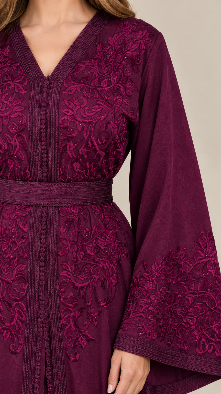 Close up of burgundy kaftan bodice embroidery and sleeve cuffs