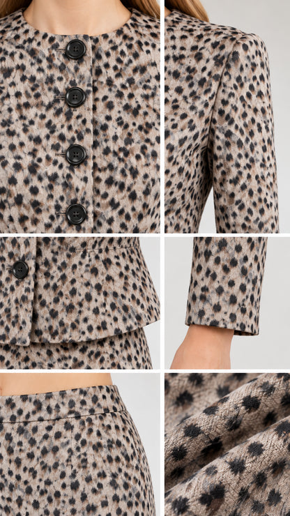 Close-up details of neckline, buttons, peplum hem, and textured fabric weave