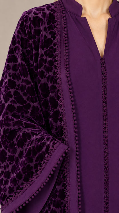 Close-up of deep purple burnout velvet pattern and delicate beaded edge trim