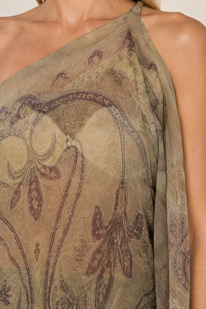 Close-up detail of sheer olive green paisley fabric and one-shoulder neckline