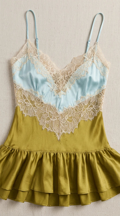 Close-up detail of contrast bust panel, floral lace trim, and ruffled hem