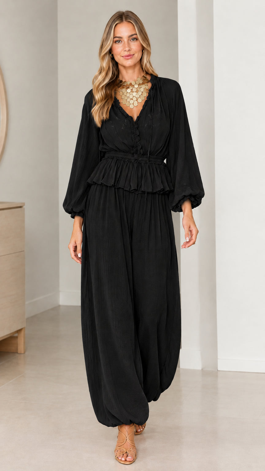 Model wearing Black smocked peplum blouse and relaxed balloon pants set