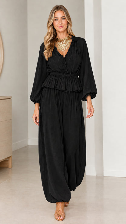 Model wearing Black smocked peplum blouse and relaxed balloon pants set