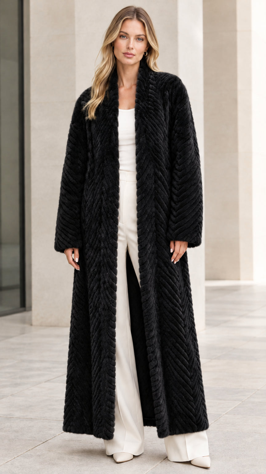 Front view of model wearing black chevron textured faux fur maxi coat
