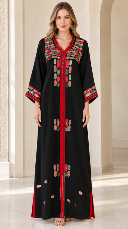 Front view of model wearing black embroidered maxi kaftan dress with red accents