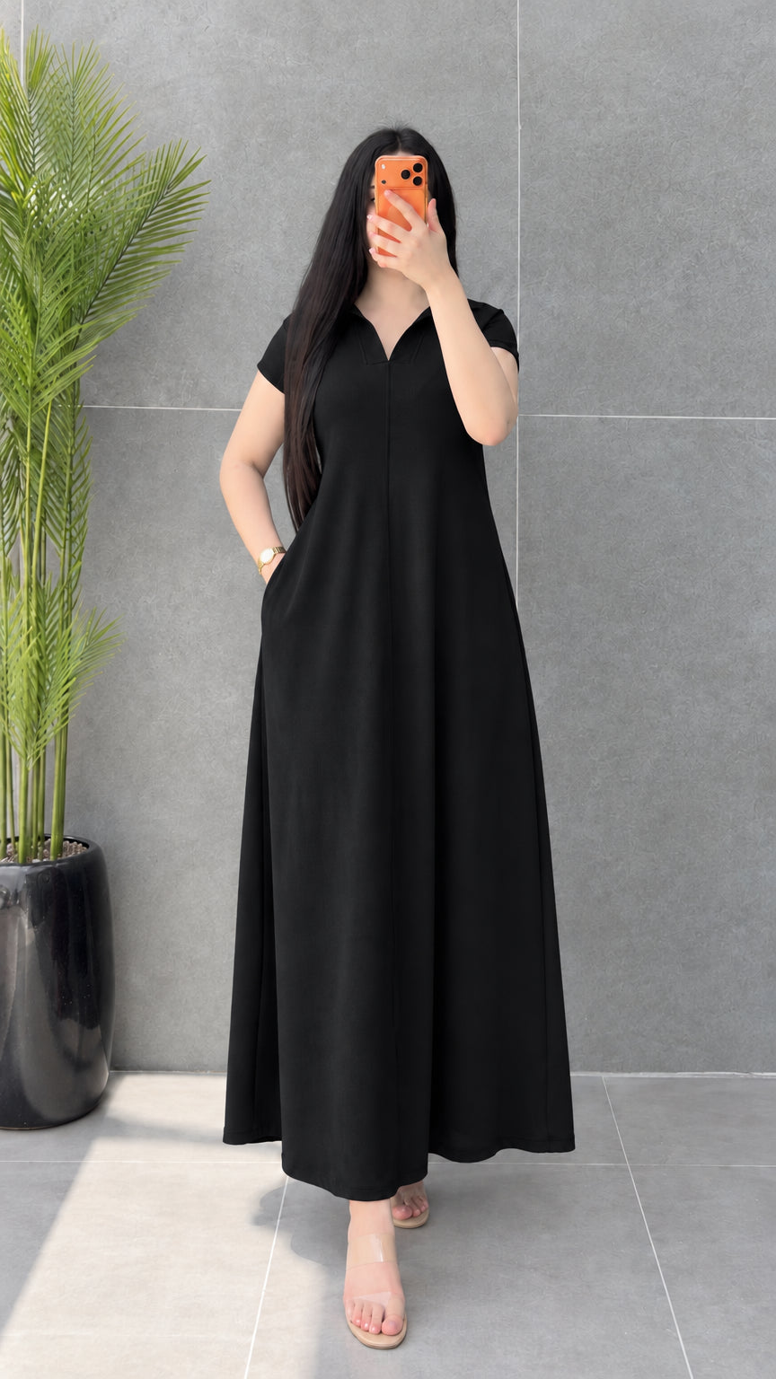 Front view of woman wearing classic Black short sleeve polo maxi dress