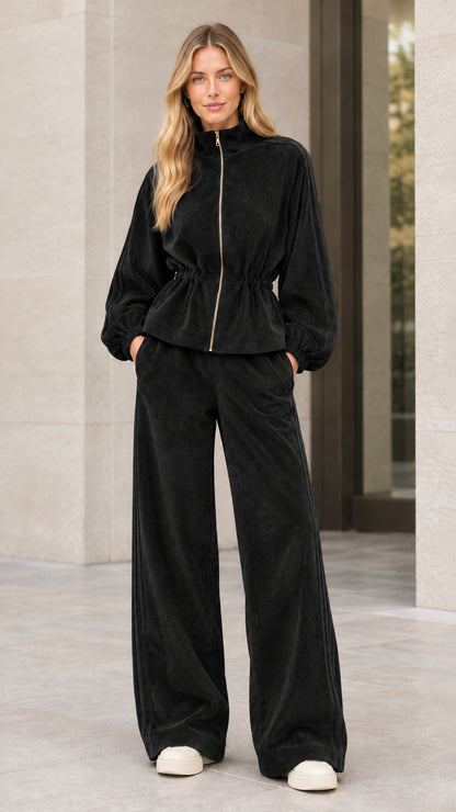 Woman wearing black corduroy zip jacket and wide leg pant set