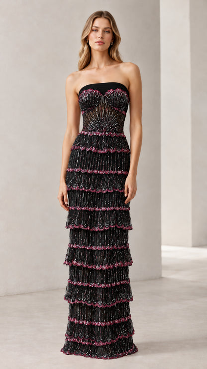 Full-length view of woman wearing black strapless beaded tiered evening gown