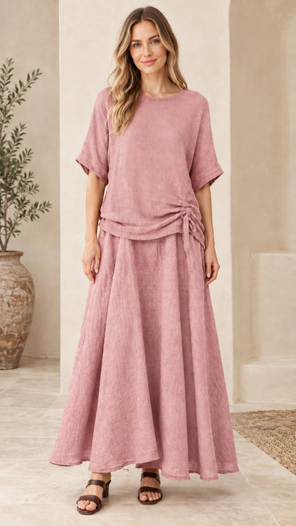 Front view of woman wearing dusty pink textured two-piece top and maxi skirt set