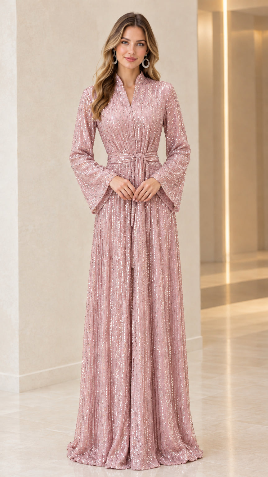 Model wearing blush pink sequin long bell sleeve maxi dress with tie belt