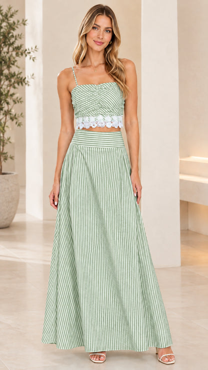 Front view of model wearing sage green striped crop top and maxi skirt set