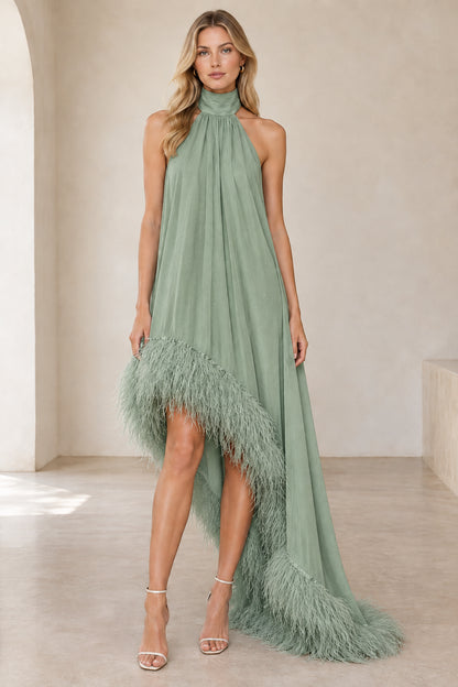 Model wearing sage green halter high-low evening gown with feather hem