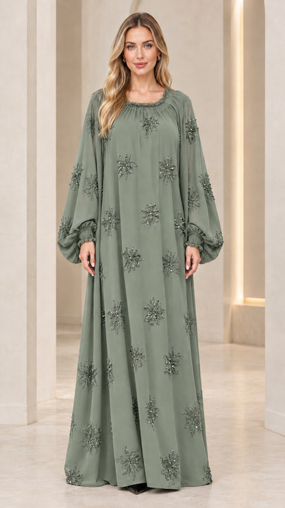 Full-length front view of model wearing sage green beaded balloon sleeve maxi dress
