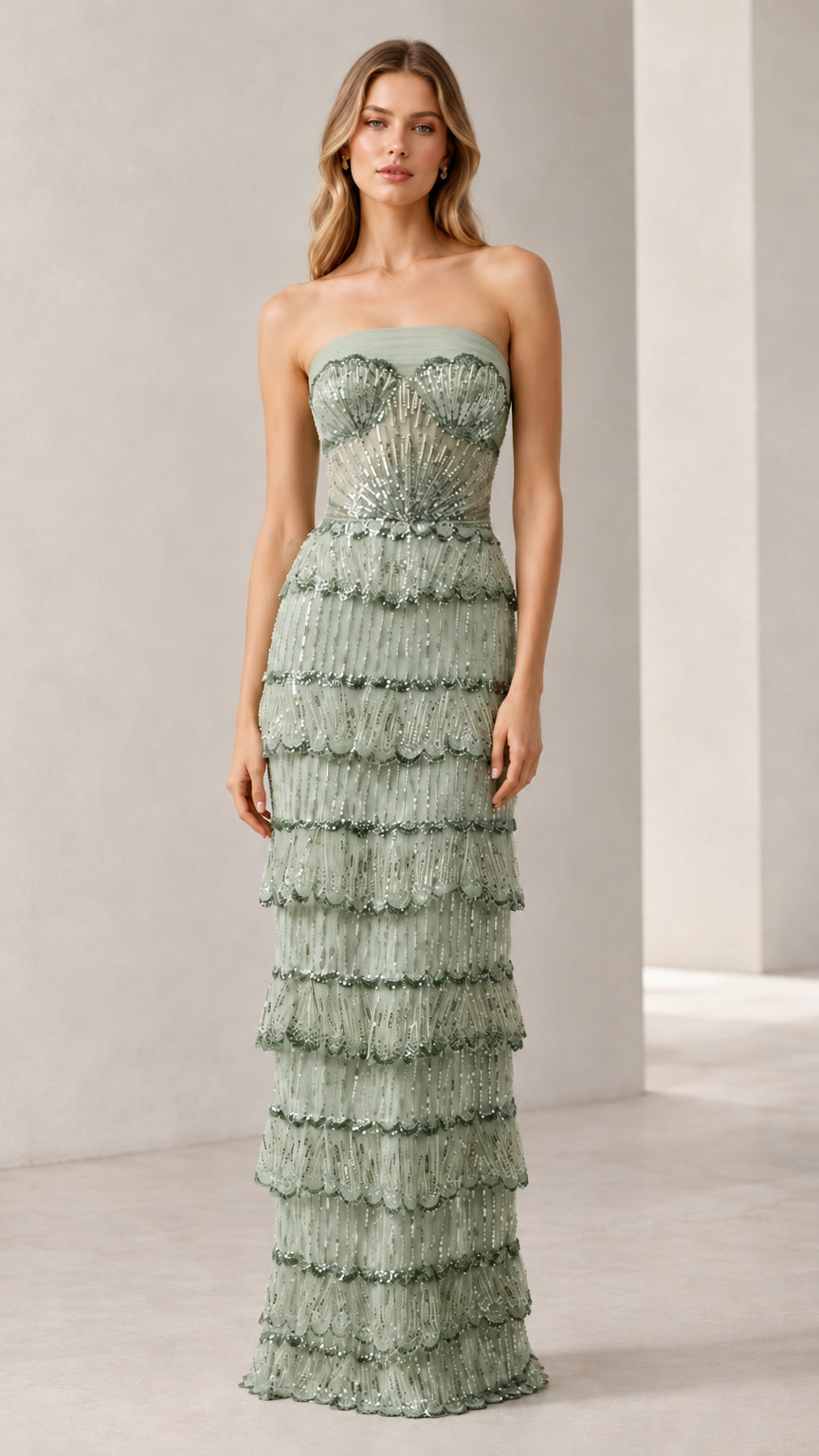 Full-length view of woman wearing sage green strapless beaded tiered evening gown