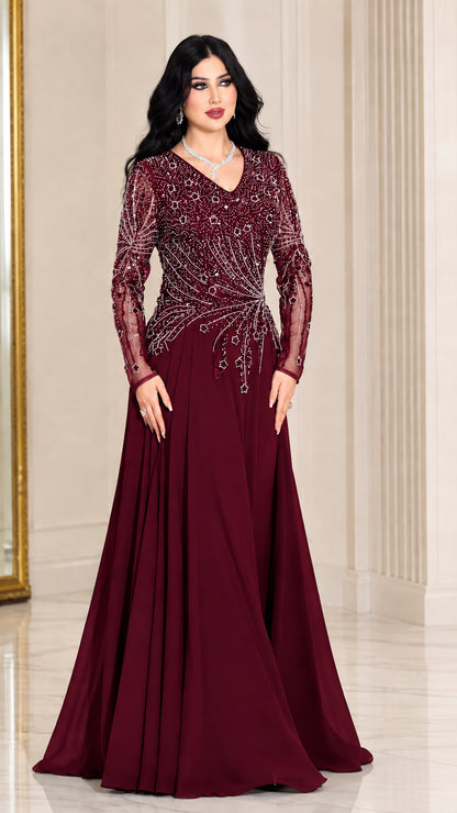 Front view of woman wearing burgundy wine red long sleeve beaded evening gown