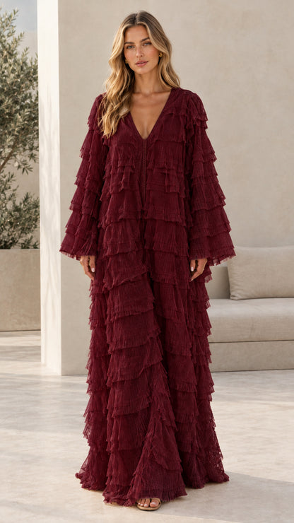 Model wearing burgundy wine red tiered fringe long sleeve maxi dress