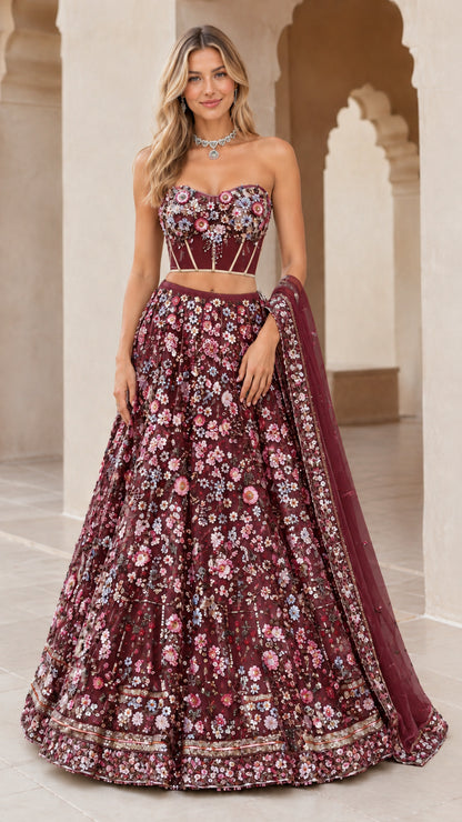 Model wearing burgundy wine red 3D floral embroidered strapless corset lehenga set