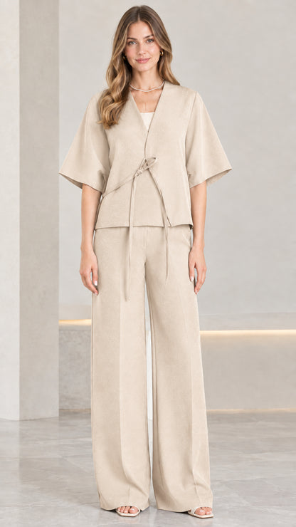 Front view of woman wearing beige tie-front kimono top and wide-leg pants set