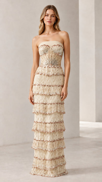 Full-length view of woman wearing champagne strapless beaded tiered evening gown