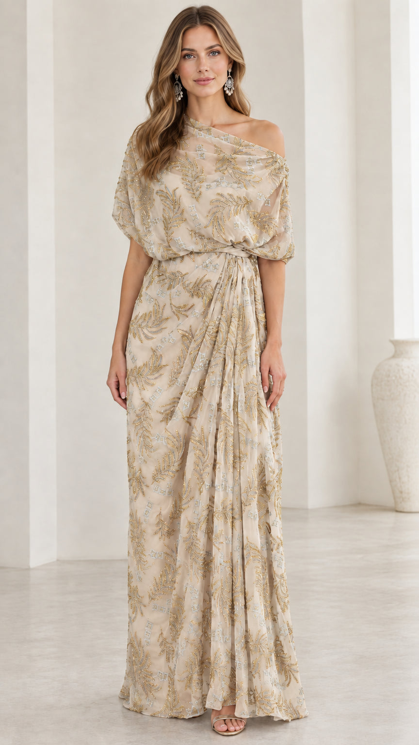 Woman wearing champagne gold one-shoulder embroidered draped maxi dress