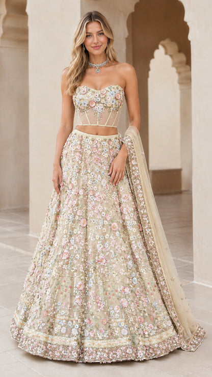 Model wearing champagne gold 3D floral embroidered strapless corset lehenga set