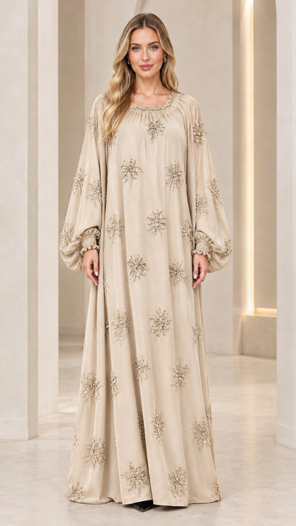 Full-length front view of model wearing champagne beige beaded kaftan maxi dress